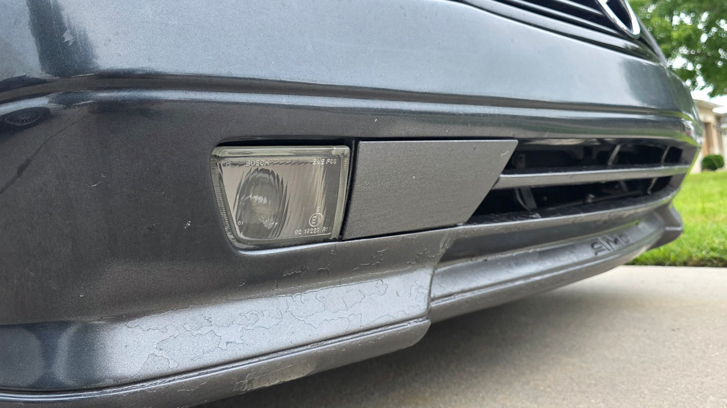 Close-up of a car's front bumper and headlight